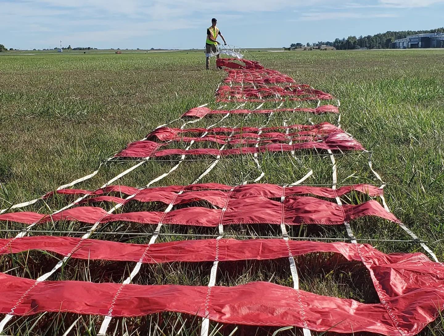 Letter banner segments laid out in a field before flight