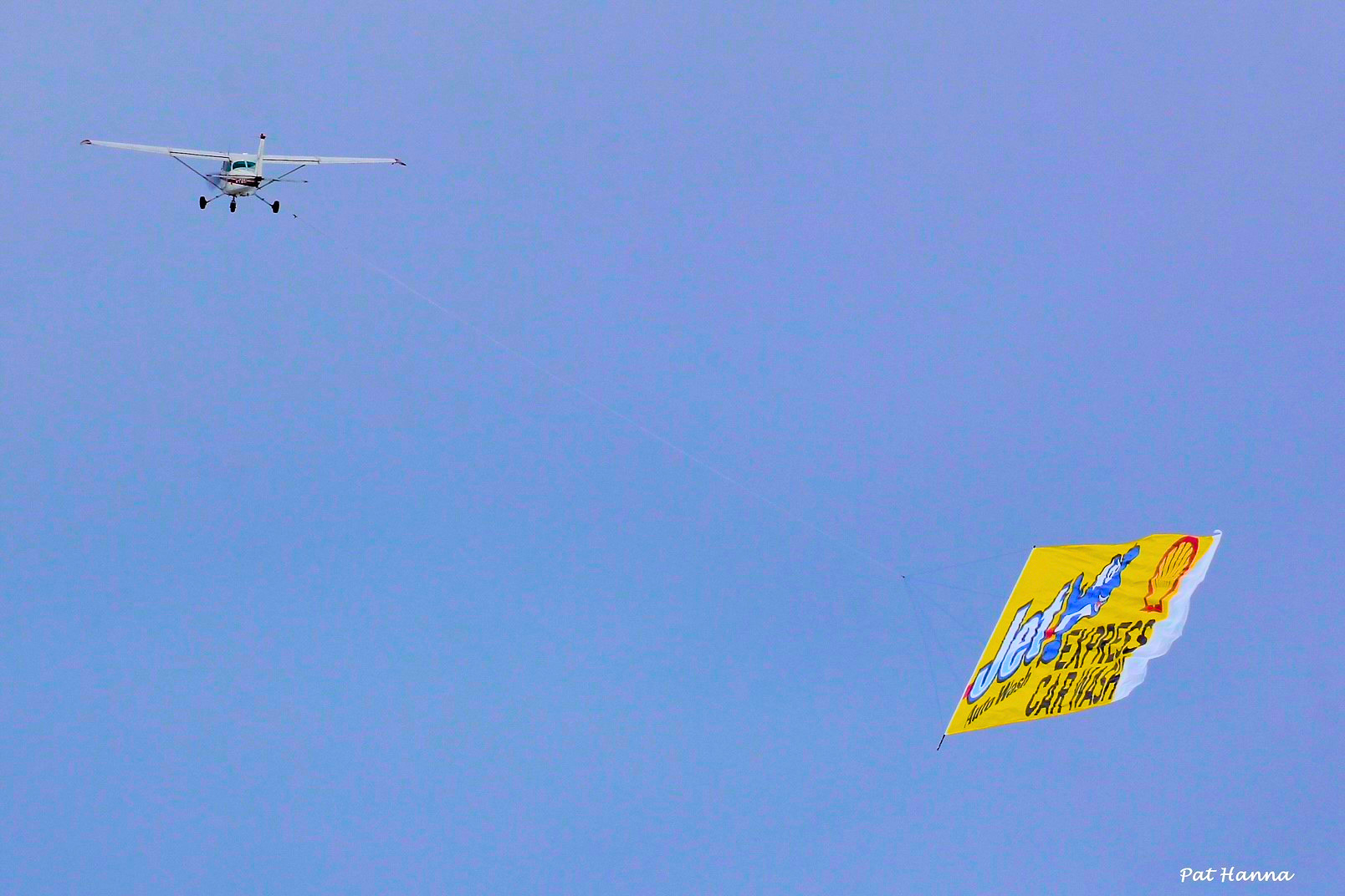 Plane towing a Jet Express Car Wash billboard banner in the sky